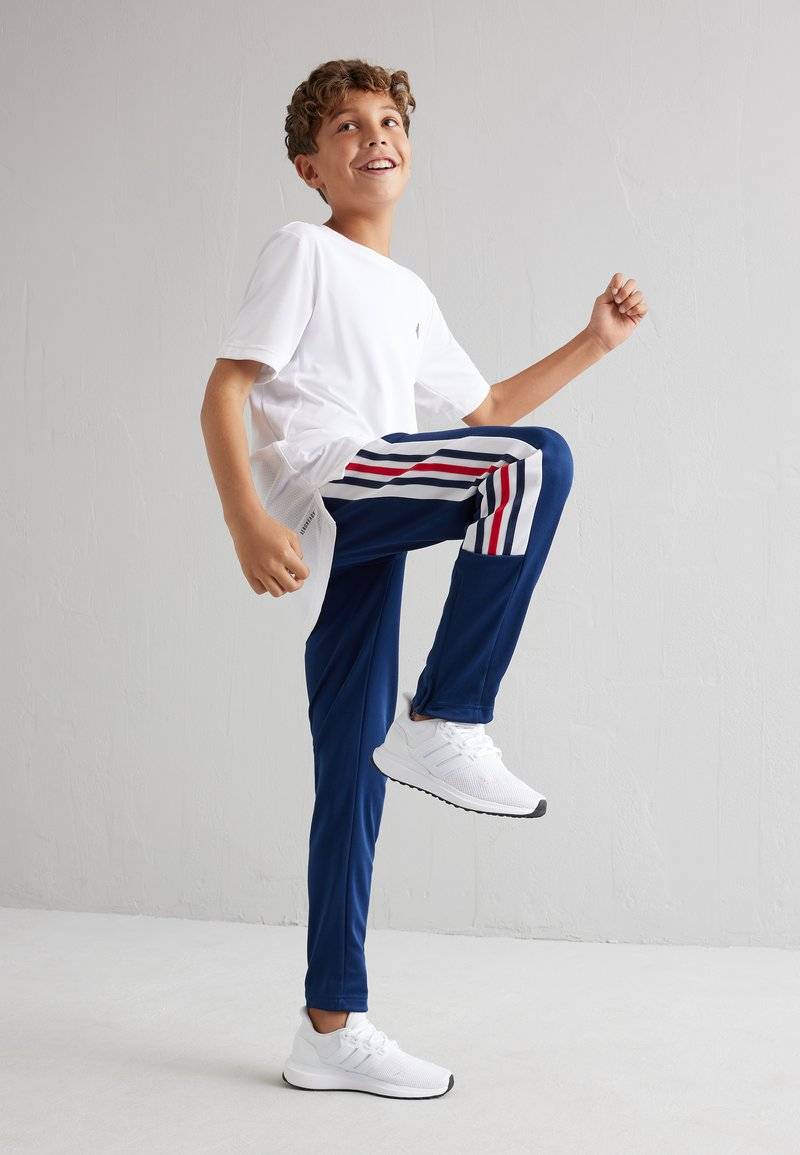 adidas Performance adidas Performance TIRO NATIONS PACK UNISEX - Tracksuit bottoms 2025