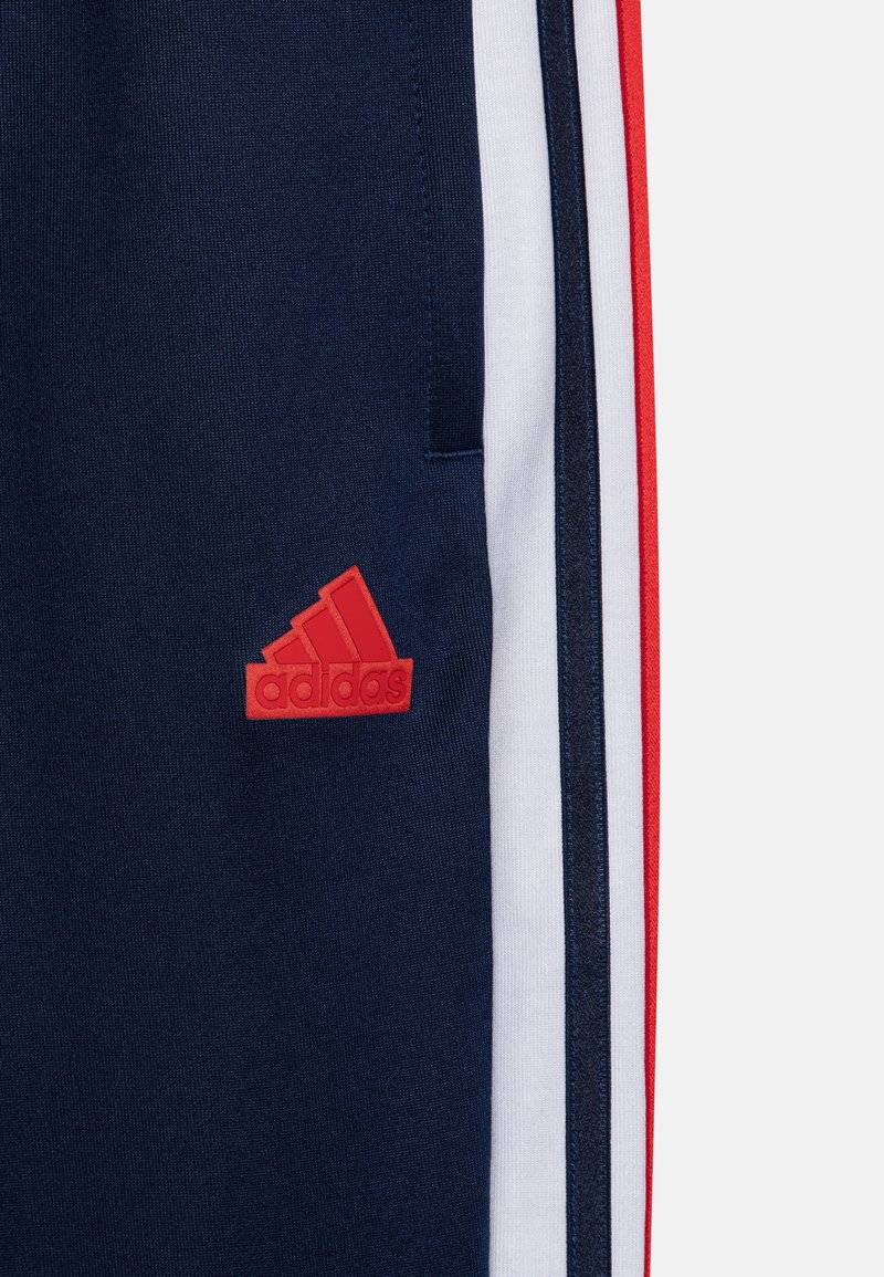 adidas Performance adidas Performance TIRO NATIONS PACK UNISEX - Tracksuit bottoms 2025