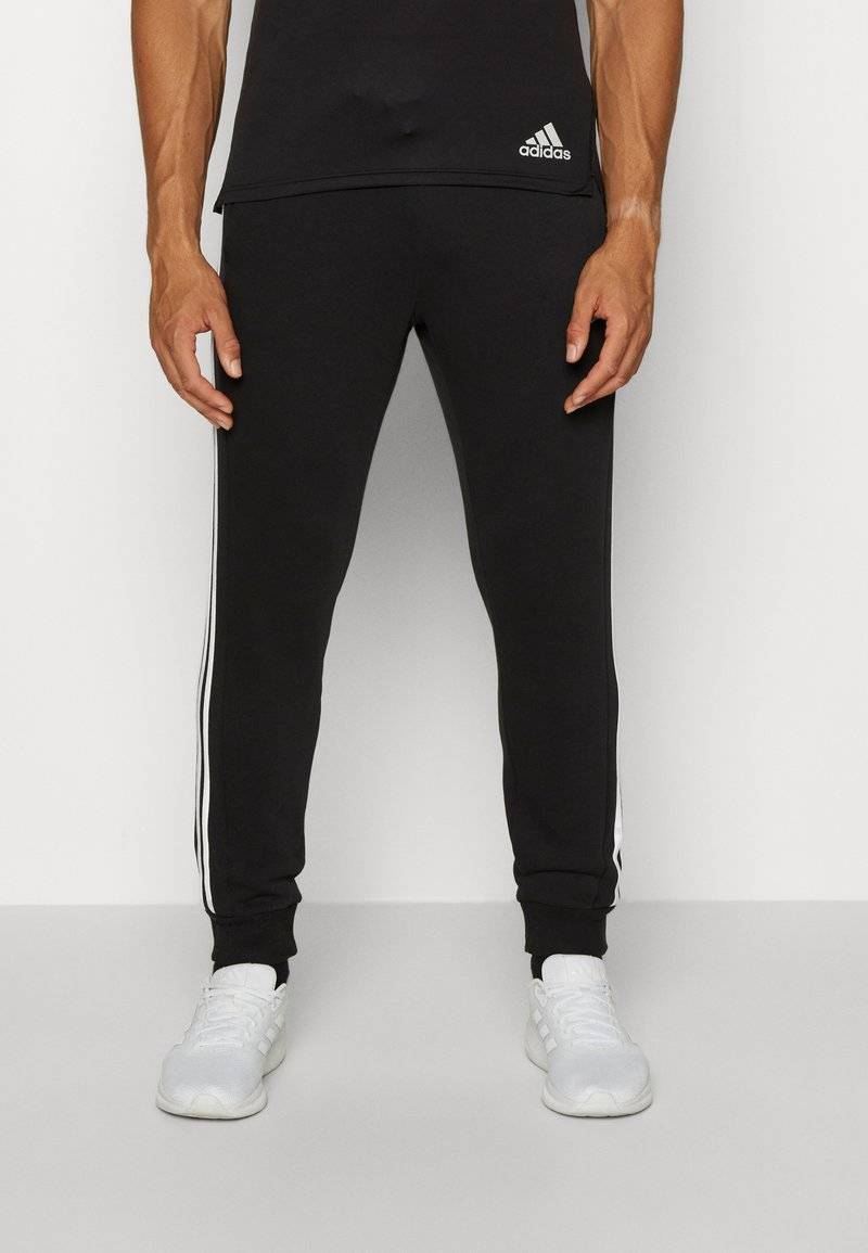 adidas Sportswear adidas Sportswear ESSENTIALS TAPERED CUFF 3 STRIPES PANTS - Tracksuit bottoms - black white Schlussverkauf
