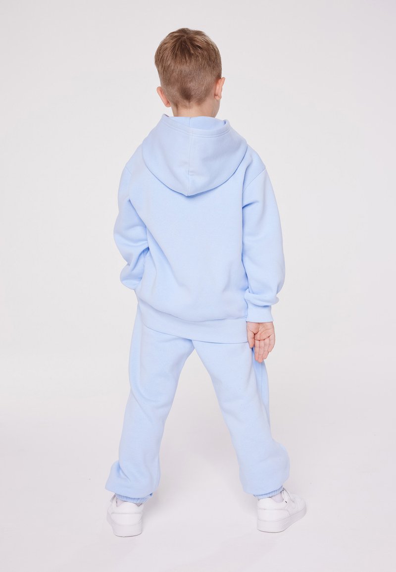 Champion Champion EXCLUSIVE PANT UNISEX - Tracksuit bottoms - light blue Jubiläumsangebot