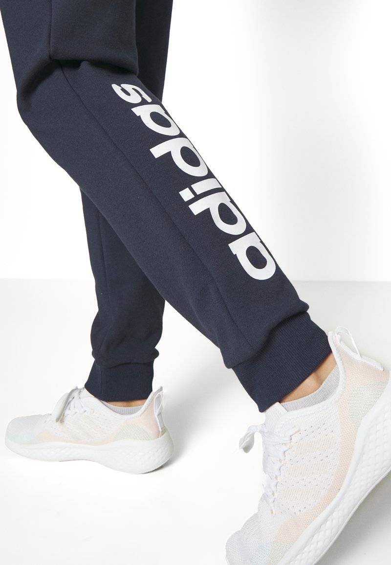 adidas Sportswear adidas Sportswear ESSENTIALS LINEAR CUFFED - Tracksuit bottoms - legend ink Super Sparpreis